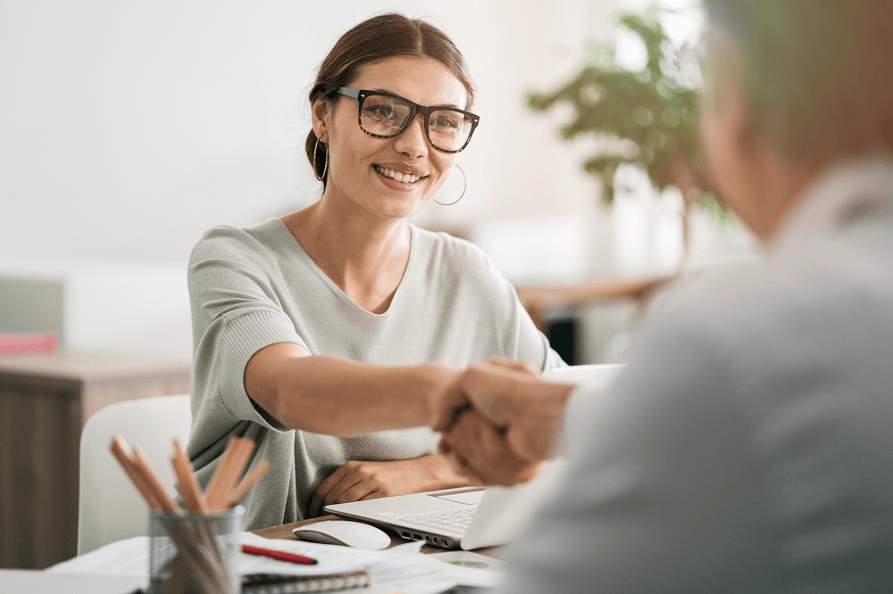 woman shaking hands and getting hired