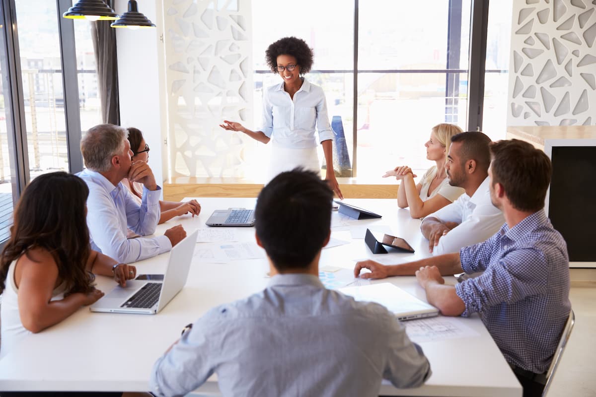 businesswoman presenting to colleagues at a meeting