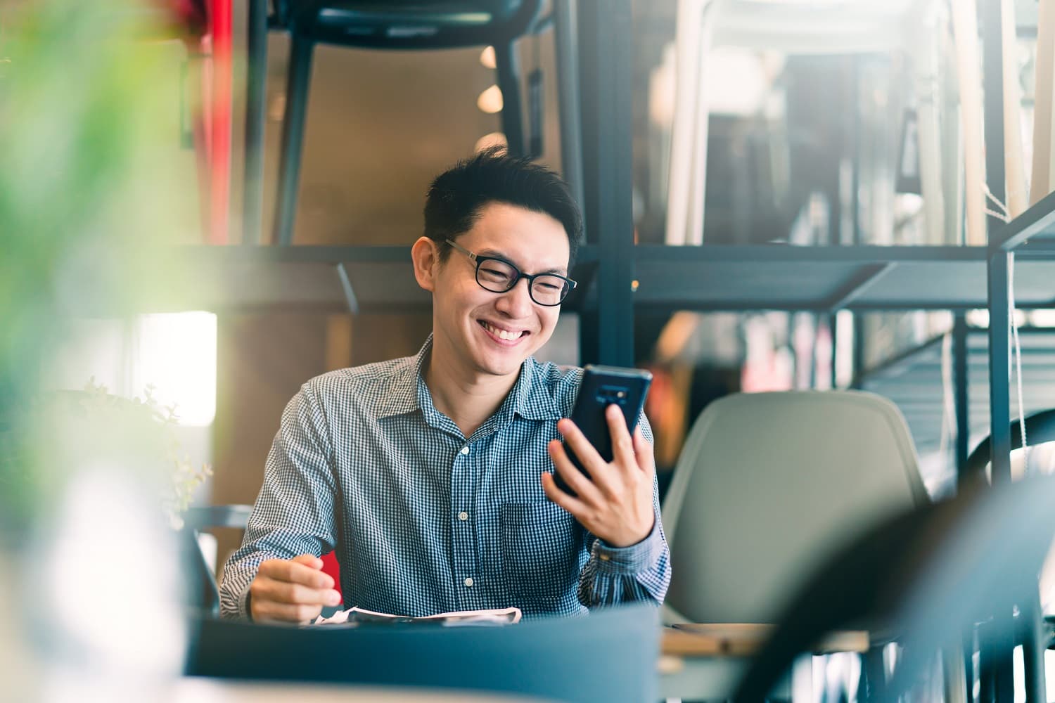 businessman at a desk using a smartphone